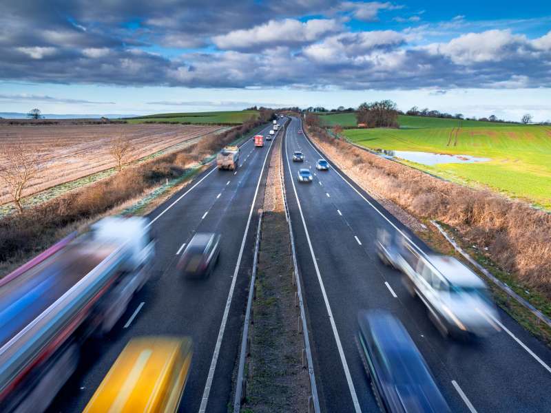 Fast,Moving,Vehicles,On,Busy,Motorway,At,The,Morning